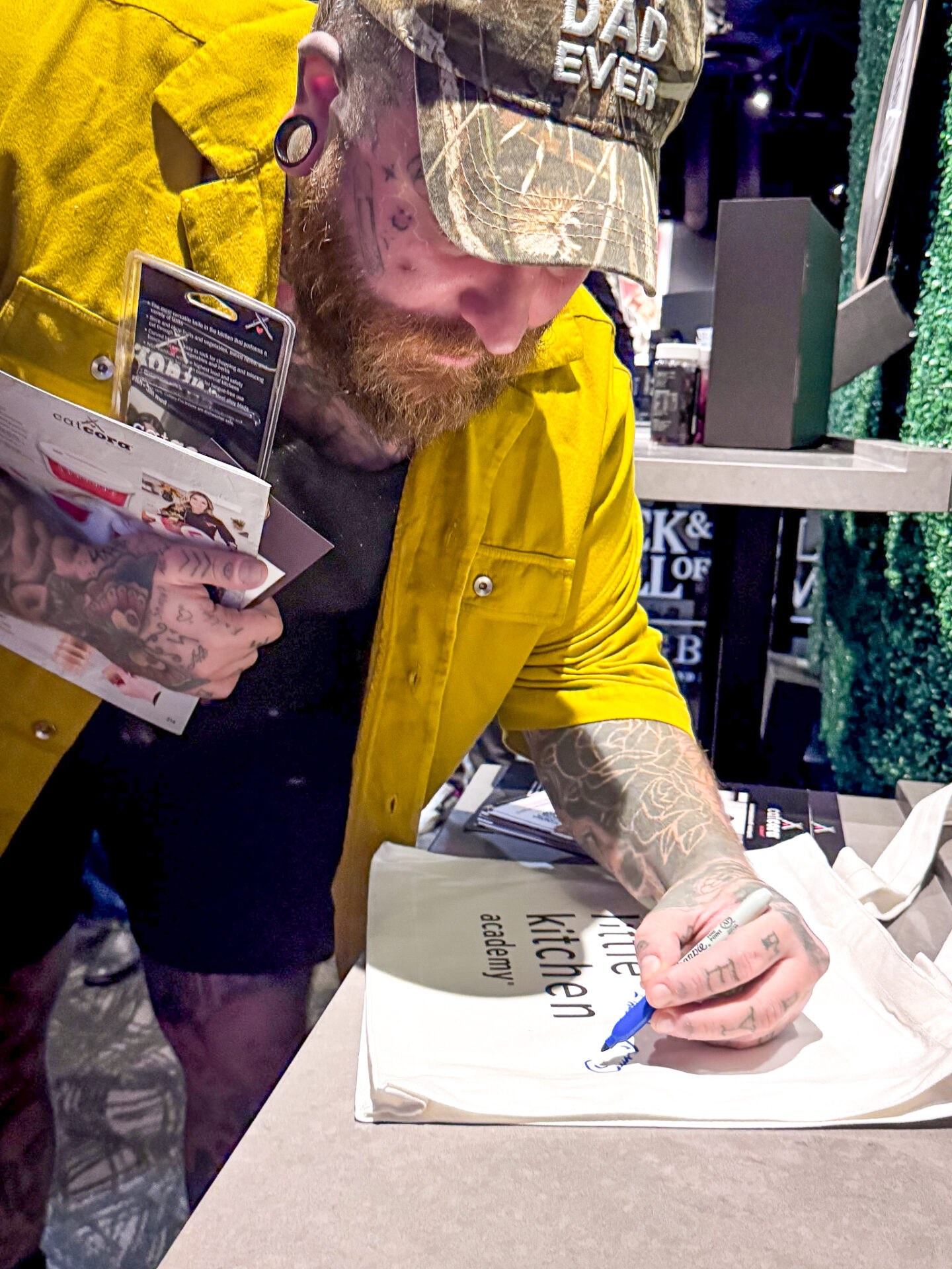 Teddy Swims signing an LKA bag to support LKA's Changing Lives from Scratch Fund 