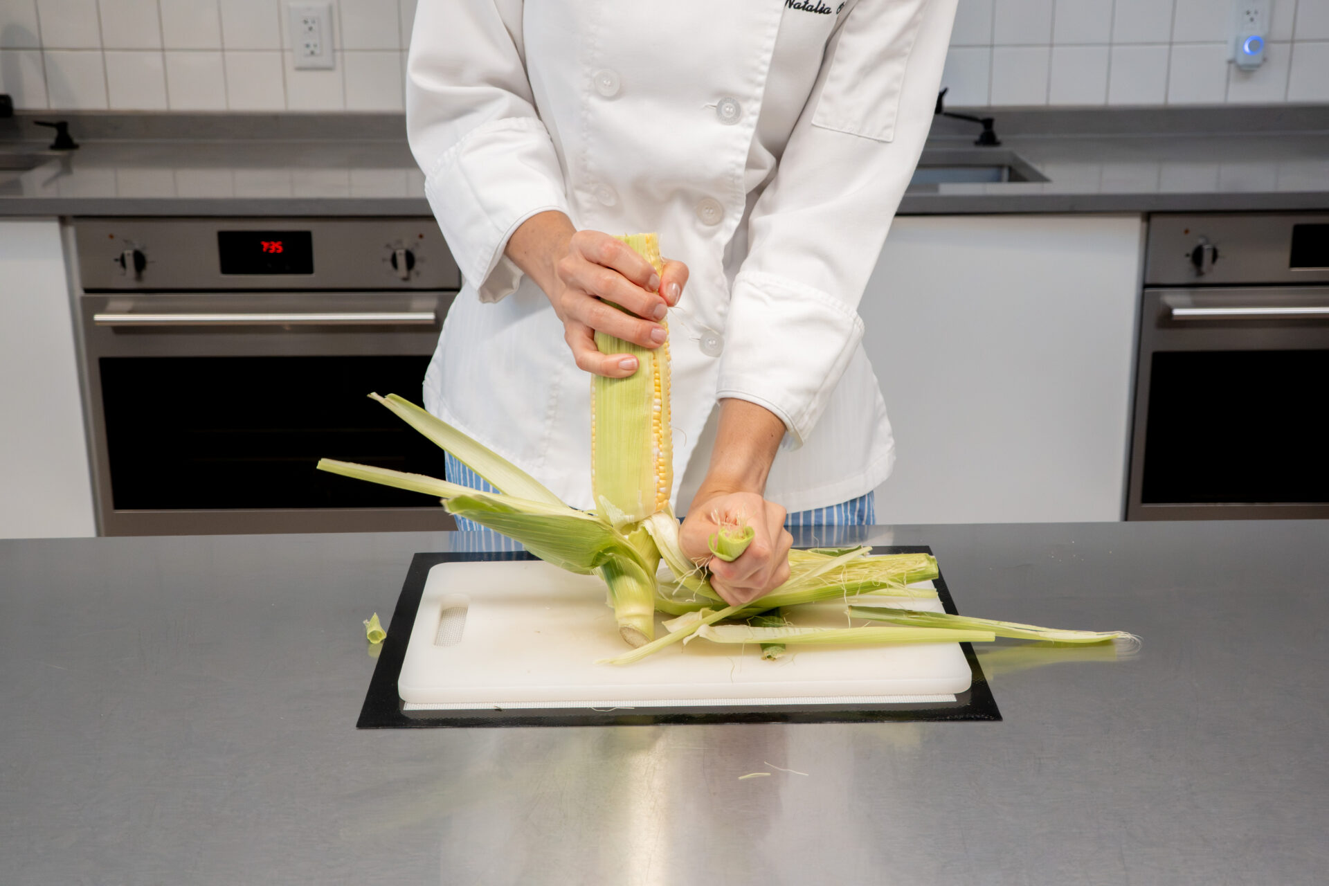 Husking corn by hand. 