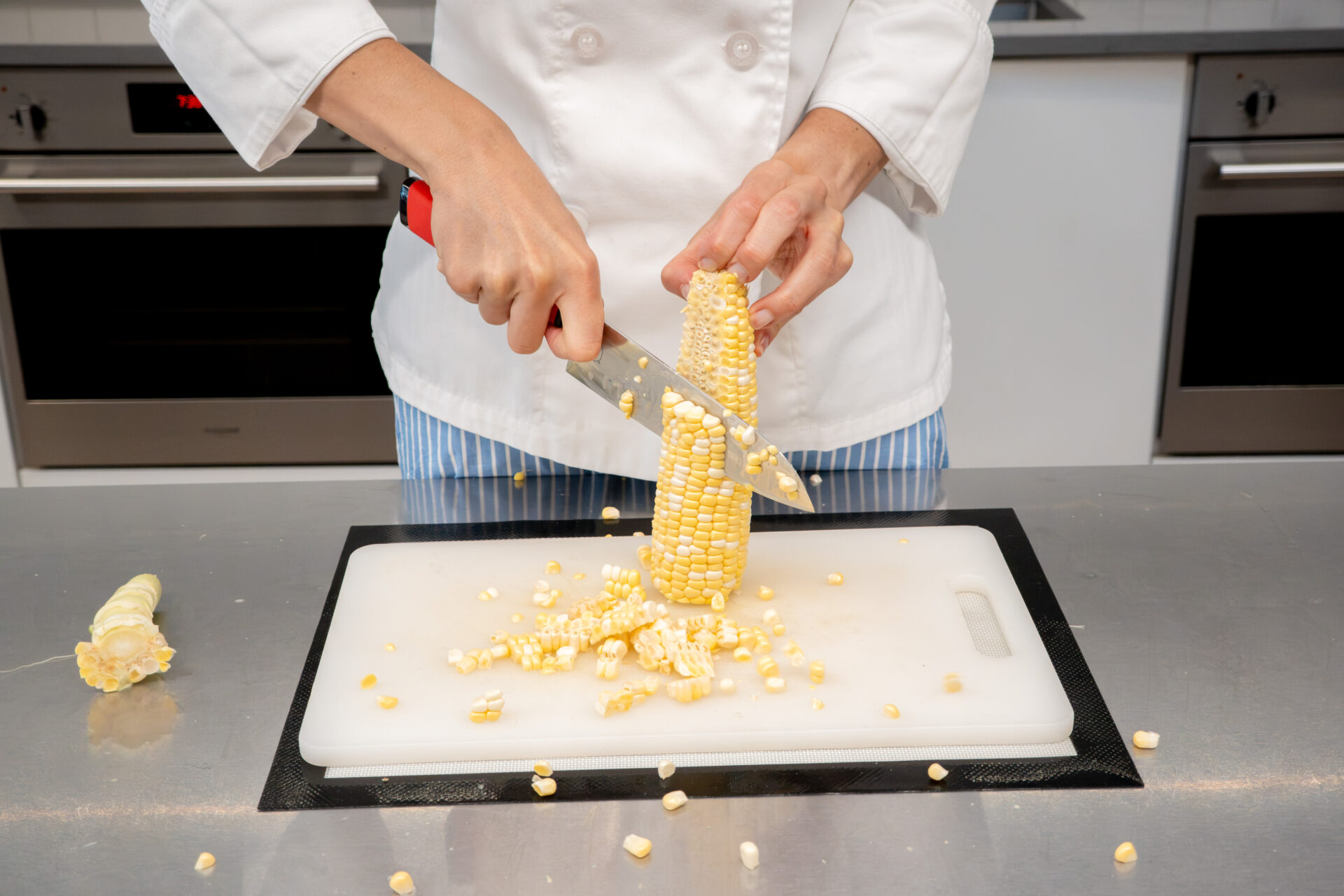 Cutting kernels from cob. 