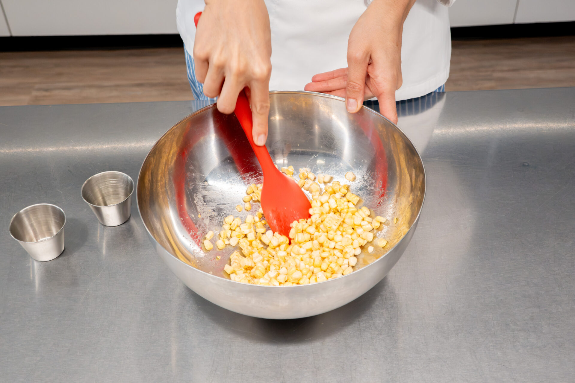 Mixing corn with seasonings. 