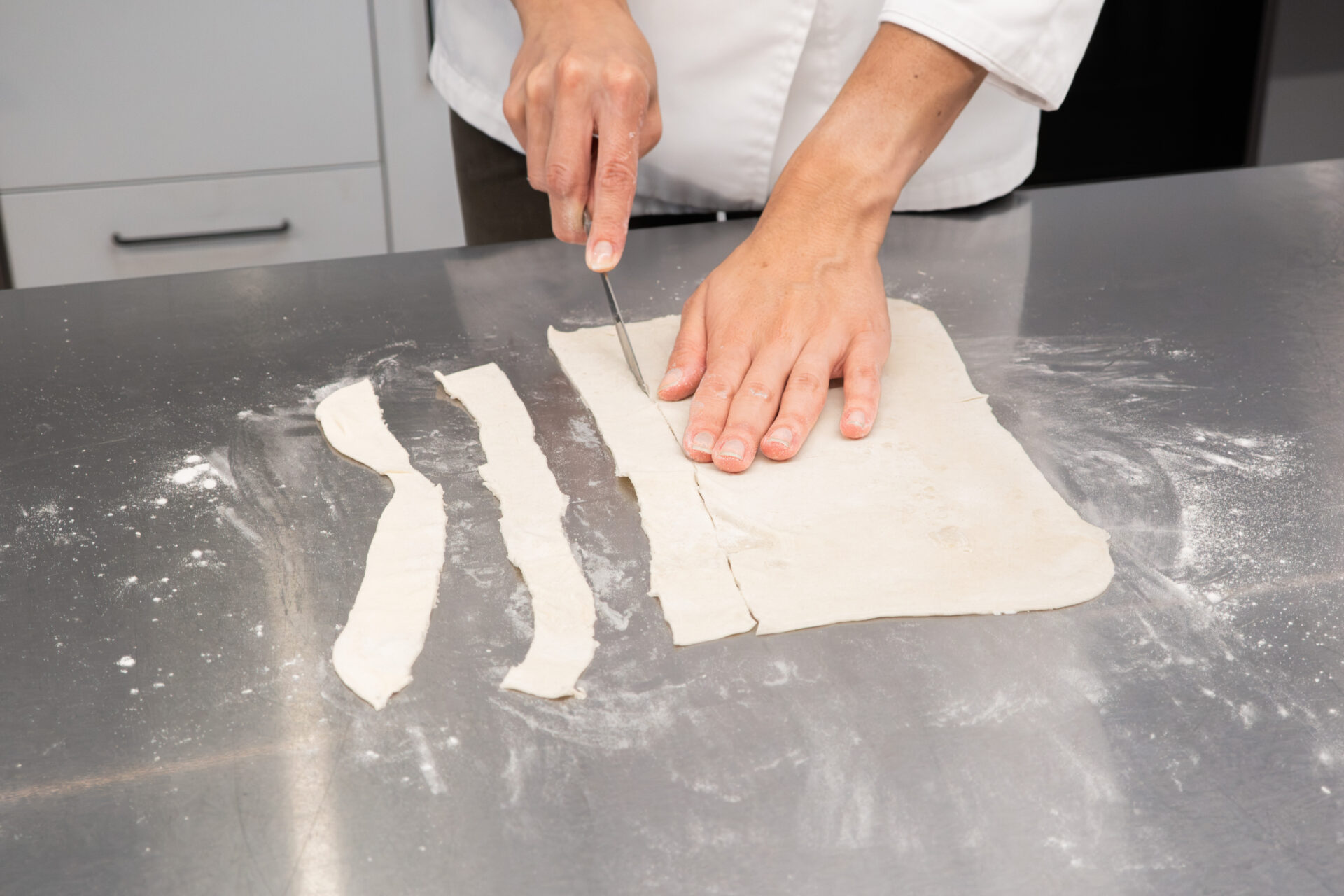 Cutting puff pastry into 1-inch strips